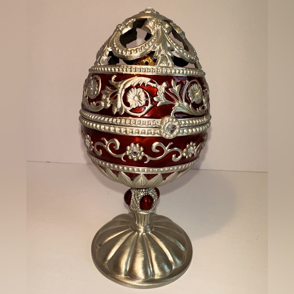 Scrolled  Egg is 6.5” X  3.5” and has substantial weight. It’s a music box.